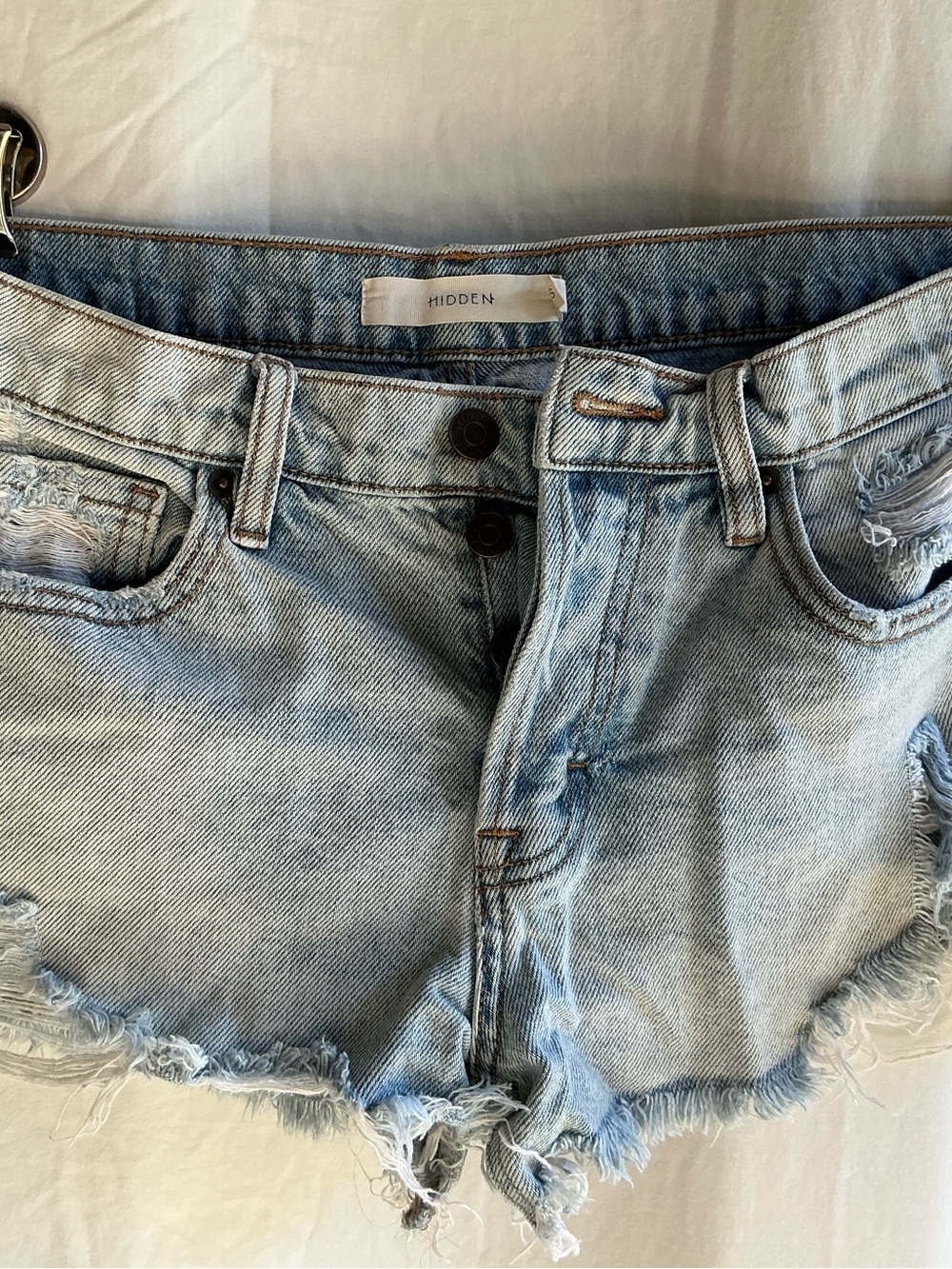 Hidden light blue distressed denim cutoff shorts